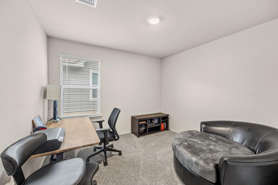A well-lit, quiet study offers a productive atmosphere for work or relaxation.