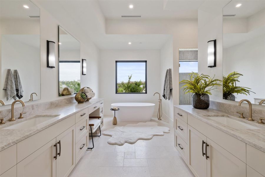 Bathroom with two vanities, a freestanding tub, and a sink Bathroom with two vanities, a freestanding tub, and a sink