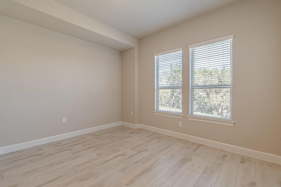 Empty room featuring light wood-style flooring and baseboards