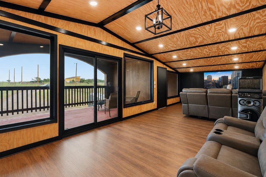 Large windows and a sliding glass door open to an inviting outdoor space, connecting interiors with the expansive views.