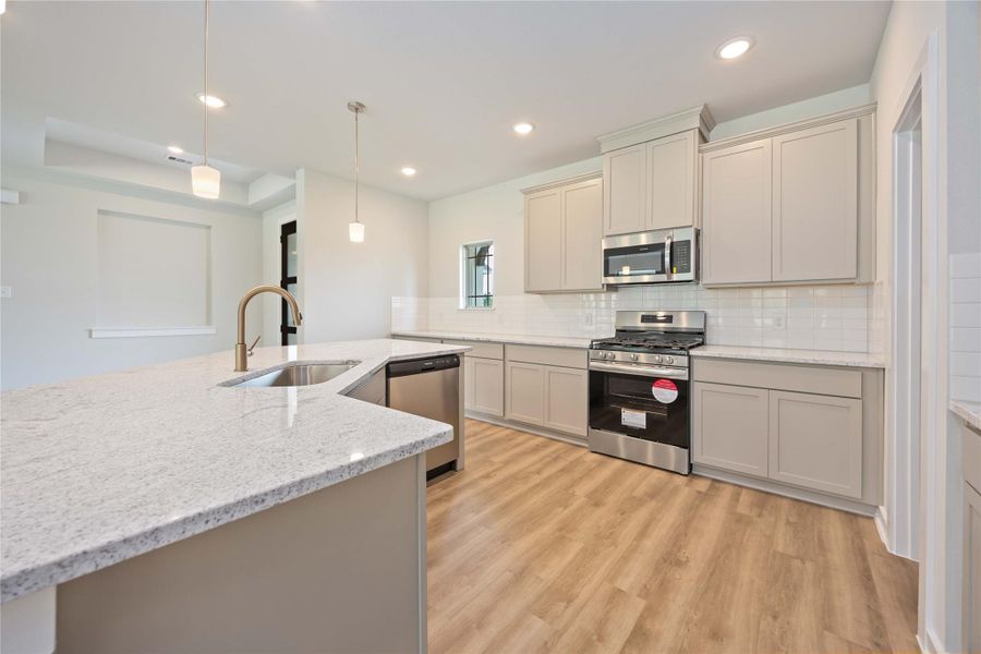 Beautiful kitchen with warm white cabinetry, light brown floors, and sleek white countertops—effortlessly elegant. Beautiful kitchen with warm white cabinetry, light brown floors, and sleek white countertops—effortlessly elegant.