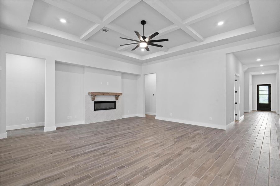 This alternative view highlights the seamless, open-concept flow from the front entry directly into the heart of the home. The expansive family room greets guests with impressive architectural detail and a sense of scale that is both grand and welcoming.
