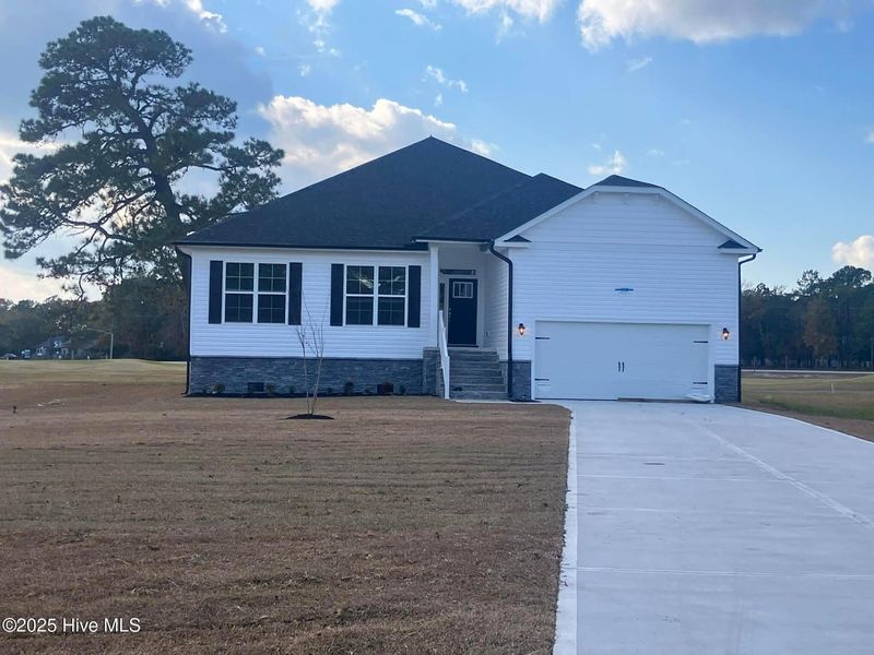 Front exterior of a new home in Fairfield Harbour, New Bern, NC, highlighting curb appeal (Image 1).