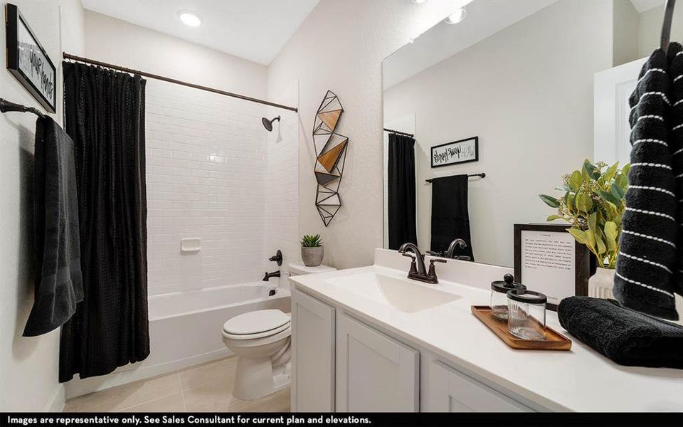 Bathroom featuring a white subway tile shower surround, a white bathtub, and a vanity with a white countertop
