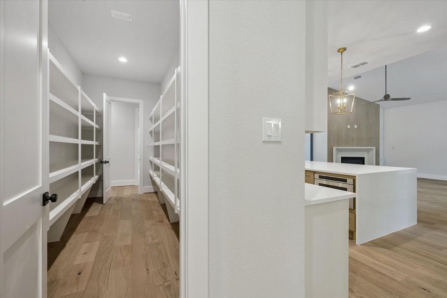 Walk-in Pantry tucked behind the Kitchen.