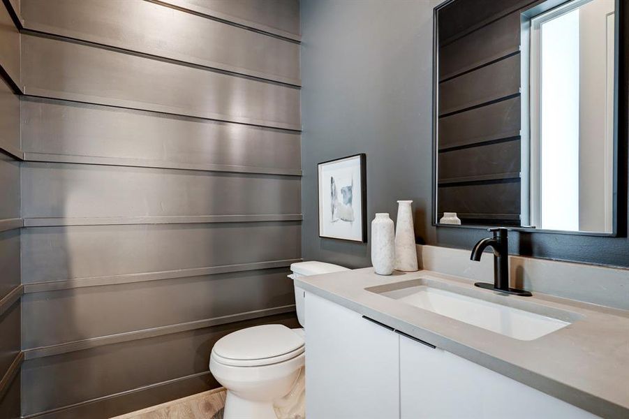 The staged model at Linear on Bell. Choose from two design packages and floor plans. Wait until you see the light fixture in this moody powder room.