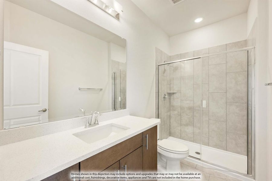 Bathroom with wood vanity, quartz countertop, large mirror, and glass-enclosed tile shower Bathroom with wood vanity, quartz countertop, large mirror, and glass-enclosed tile shower