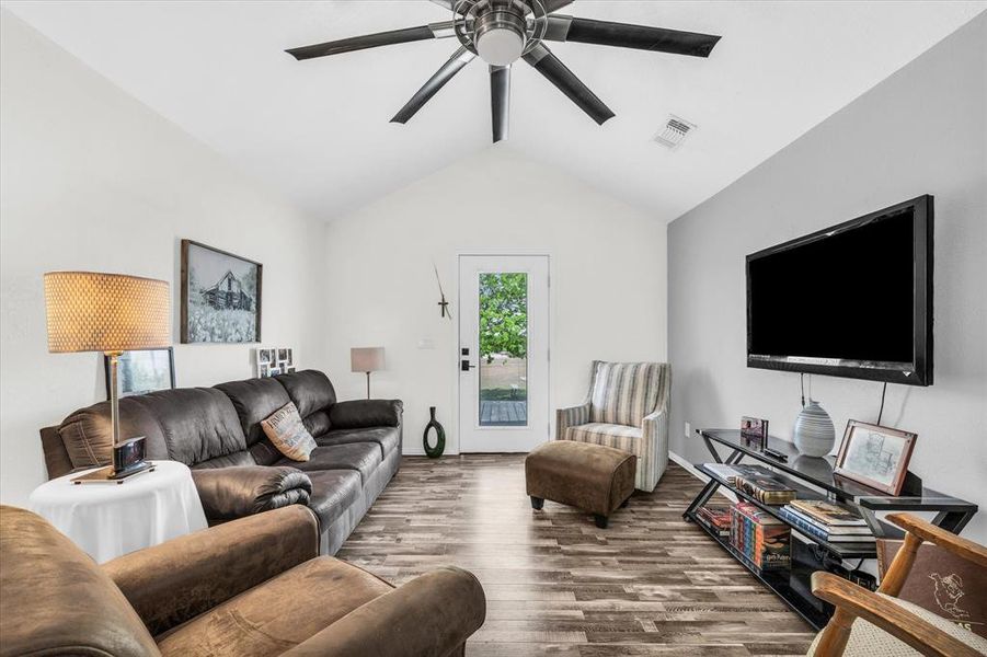 Living area with wood finished floors and a ceiling fan