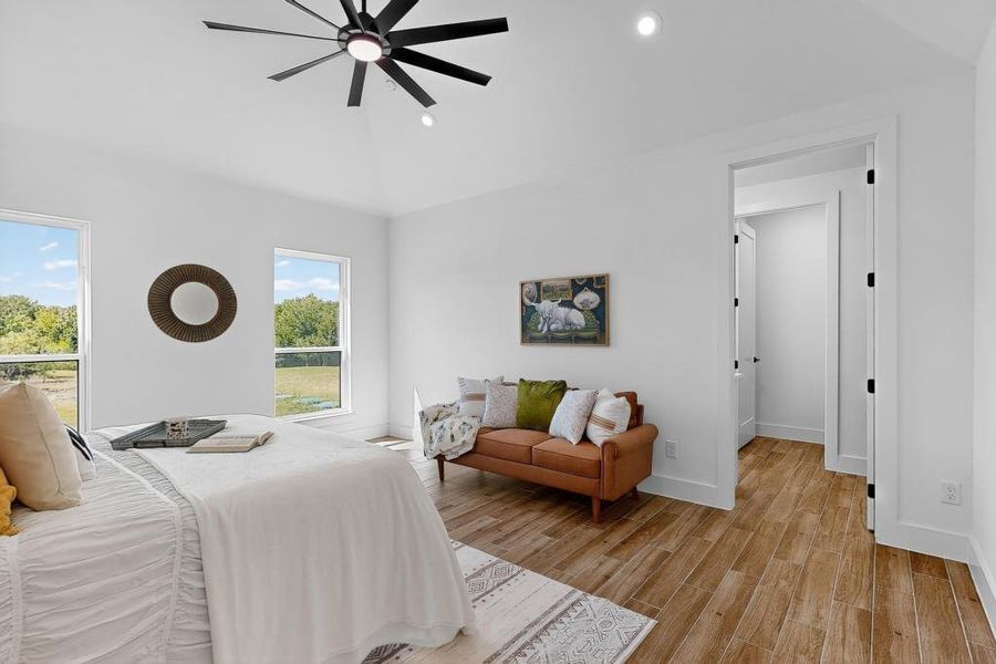 Bedroom featuring wood finished floors, recessed lighting, ceiling fan, and vaulted ceiling