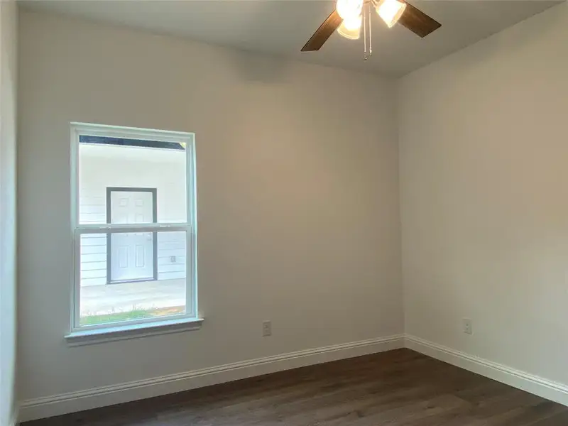 Bedroom featuring dark wood-type flooring and a ceiling fan Bedroom featuring dark wood-type flooring and a ceiling fan