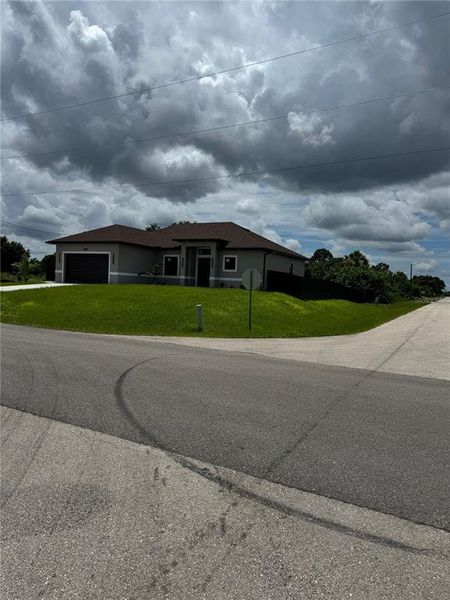 Front exterior of a new home in , Lehigh Acres, FL, highlighting curb appeal (Image 17).