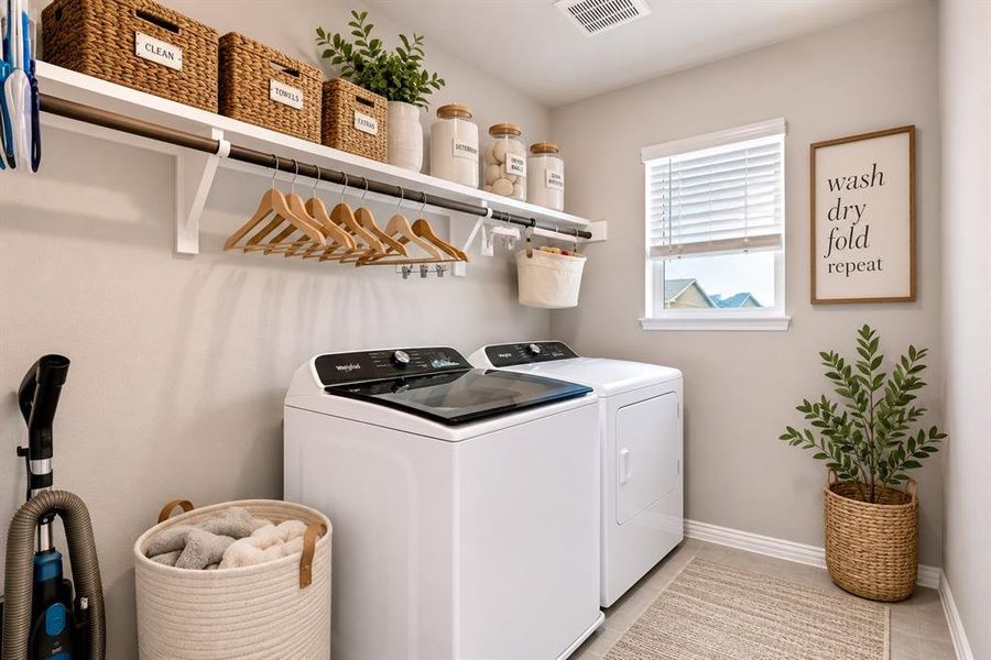 *Virtually Staged* Dedicated laundry room featuring white appliances and light-toned walls