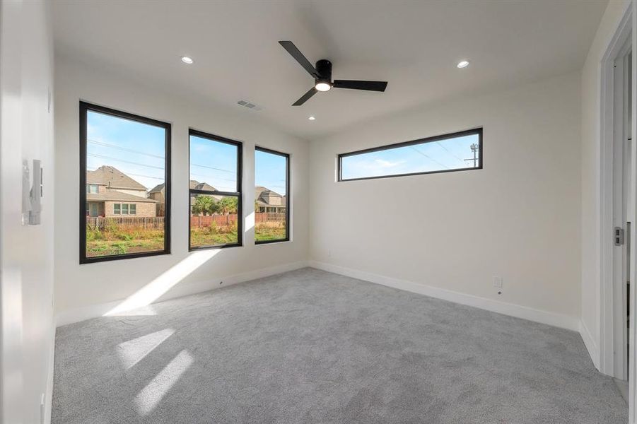 Unfurnished bedroom with a ceiling fan, light colored carpet, and recessed lighting Unfurnished bedroom with a ceiling fan, light colored carpet, and recessed lighting