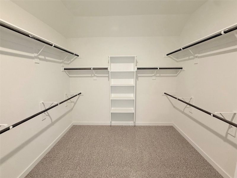 Walk in closet featuring light carpet Walk in closet featuring light carpet