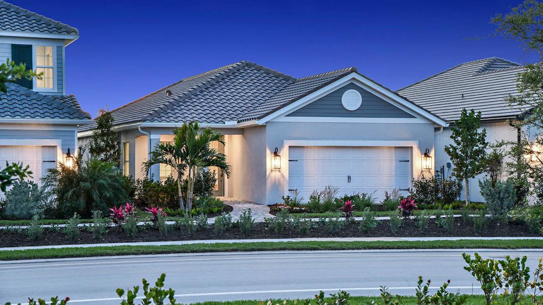 Front exterior of a new home in SkySail Real Estate and Homes for Sale in Naples, FL - Neal Communities, Naples, FL, highlighting curb appeal (Image 22).