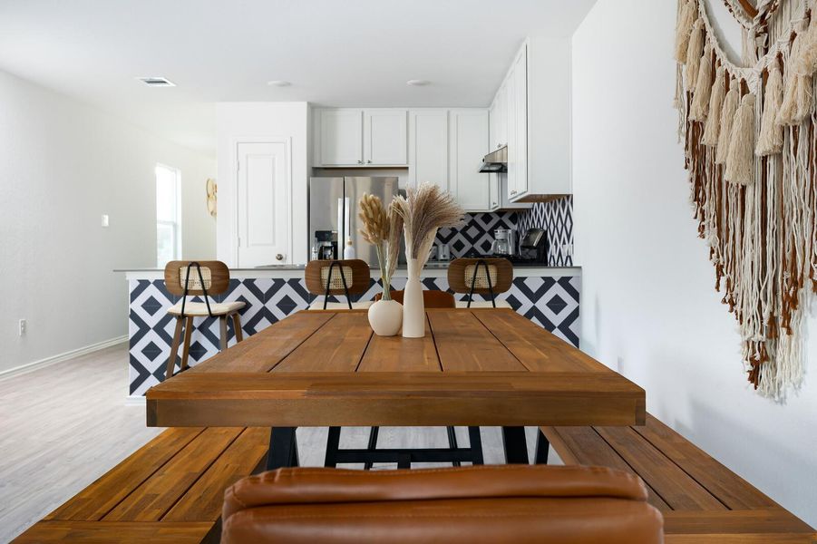 Dining space with light wood-style flooring Dining space with light wood-style flooring
