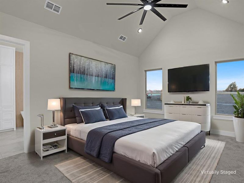 Carpeted bedroom with high vaulted ceiling and ceiling fan