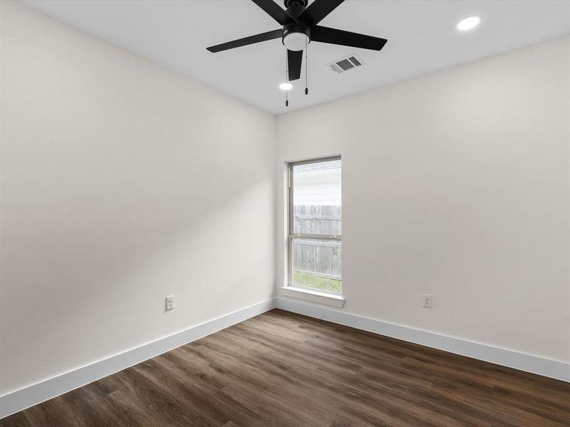 Unfurnished room featuring dark wood finished floors, recessed lighting, and a ceiling fan