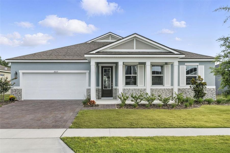Front exterior of a new home in Meadowlark Landing, Apopka, FL, highlighting curb appeal (Image 1).