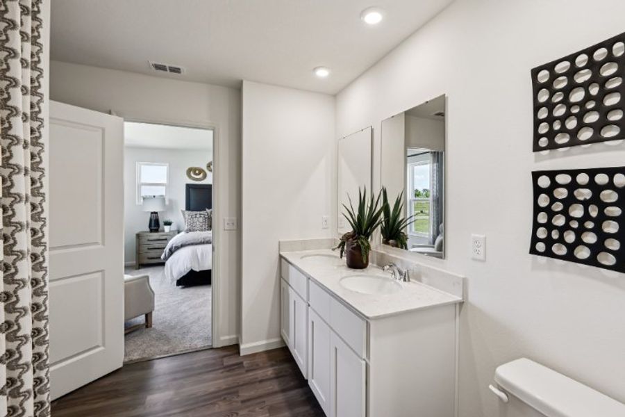 A bathroom with a bed and sink. A bathroom with a bed and sink.