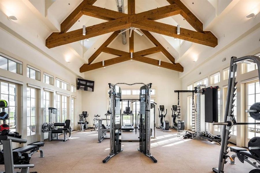 Gym with high vaulted ceiling and beamed ceiling