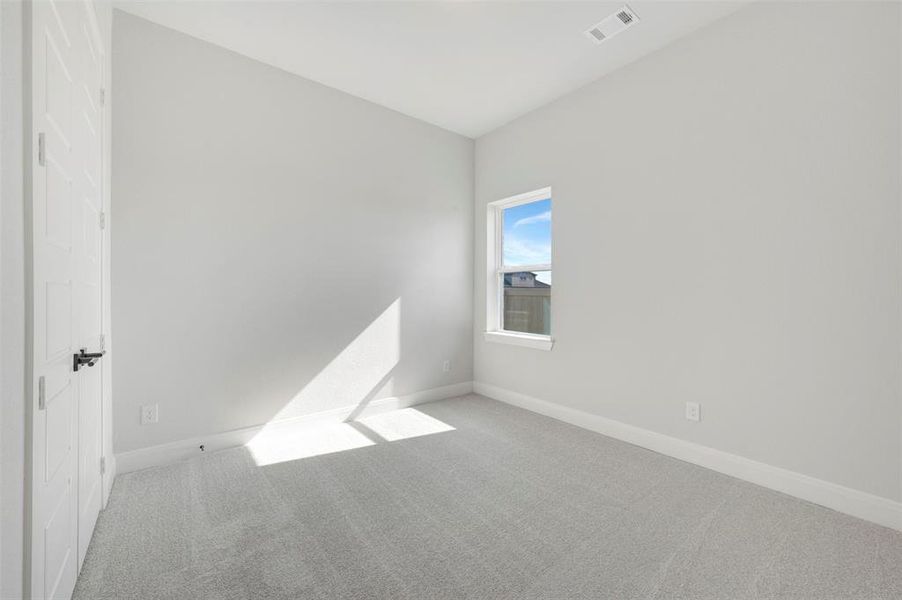Carpeted empty room with baseboards