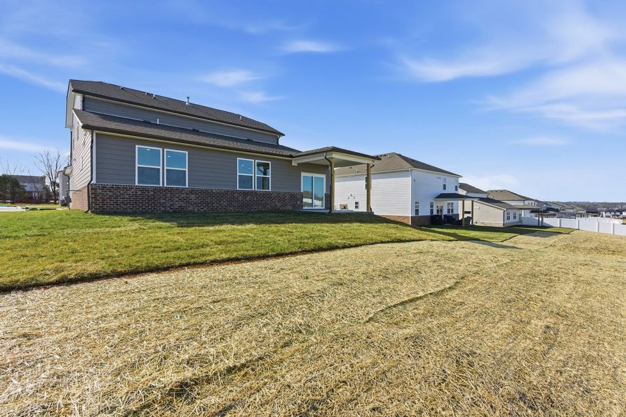 A house with a grass yard.