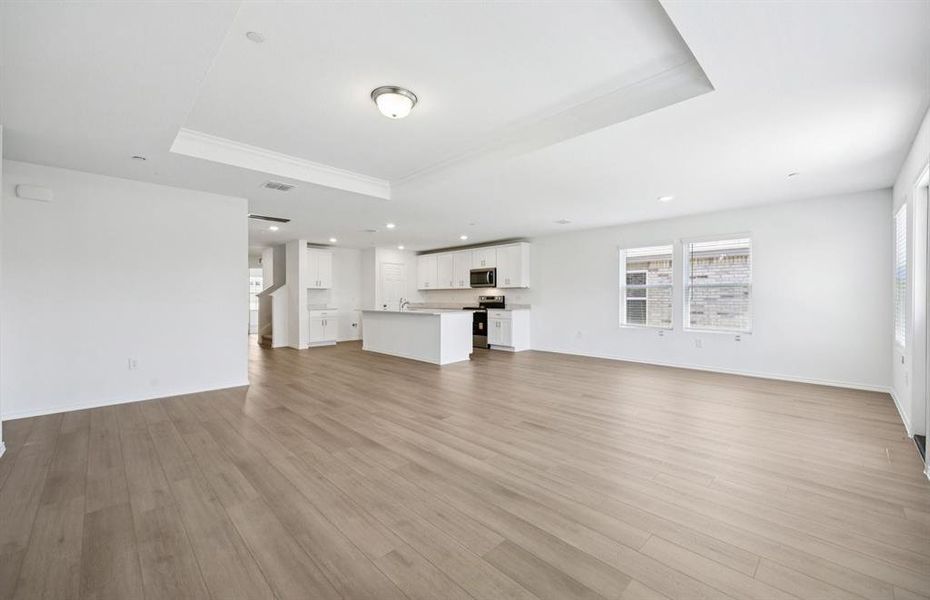 Open concept gathering room creating a spacious and inviting atmosphere *Real home pictured Open concept gathering room creating a spacious and inviting atmosphere *Real home pictured