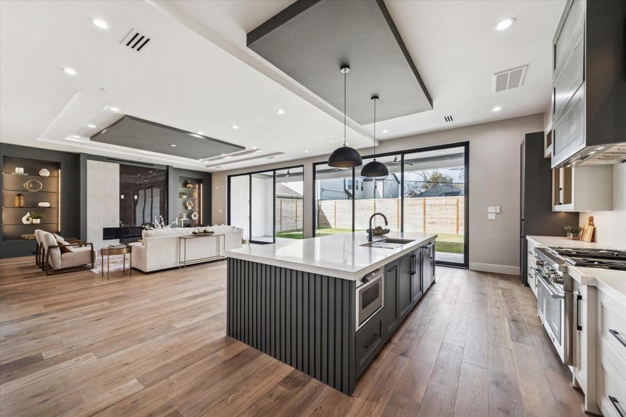 The open layout allows effortless connection to the expansive living area, while a convenient pass-through leads directly into the dining room—making this kitchen as ideal for entertaining as it is for everyday living.