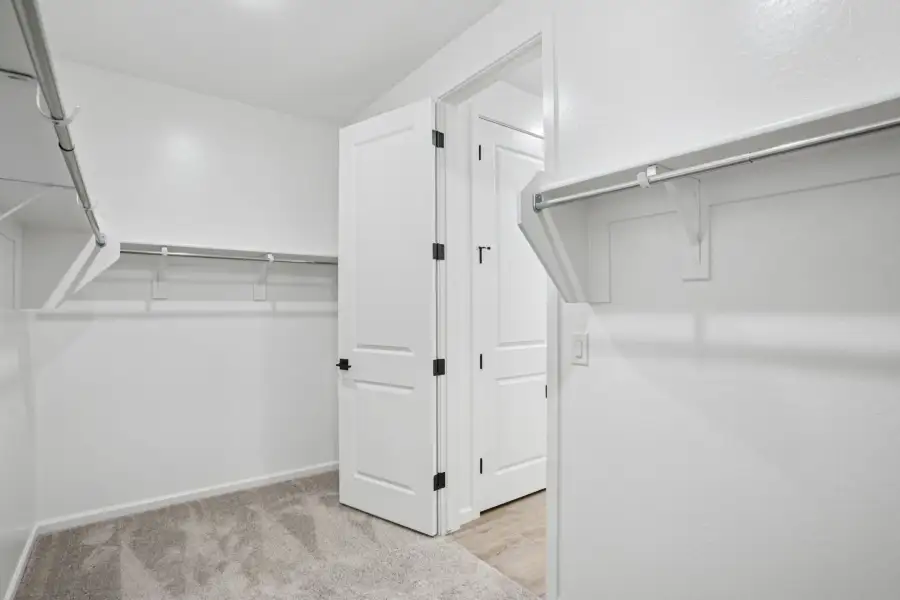 Primary walk in closet - Stonebridge Model Home. Finishes and options may vary by community