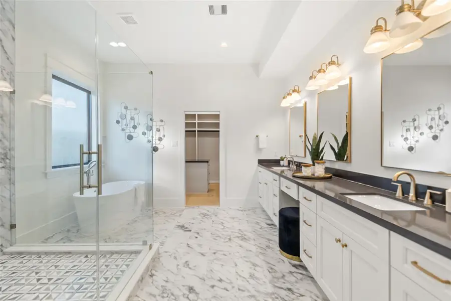 From this angle, you get the full luxury moment—your freestanding soaking tub sits perfectly beside the marble shower, while the walk-in closet entry is tucked just beyond, keeping everything connected and functional. It’s a layout that makes everyday living feel intentional, polished, and indulgent without trying too hard.