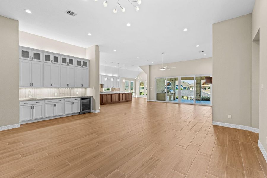 Another view of the main living space showcasing the spacious flow into the kitchen and outdoor patio, perfect for entertaining or everyday living.