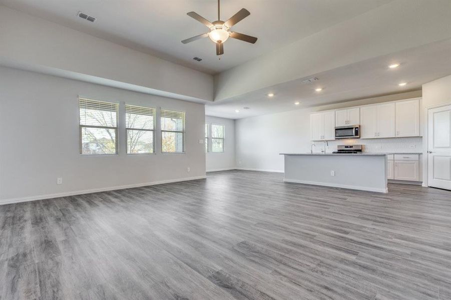 Unfurnished living room with light wood finished floors, recessed lighting, and a ceiling fan