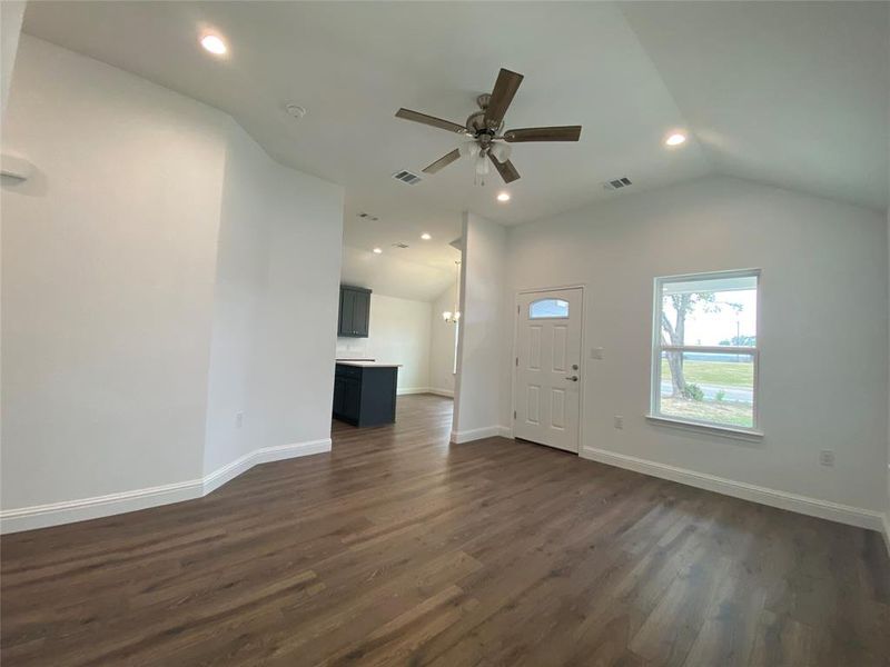 Living room with recessed lighting, lofted ceiling, dark wood-type flooring, and ceiling fan Living room with recessed lighting, lofted ceiling, dark wood-type flooring, and ceiling fan