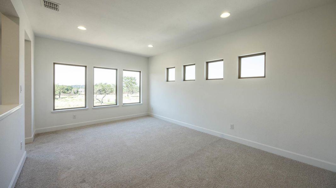 Empty room featuring light colored carpet and recessed lighting