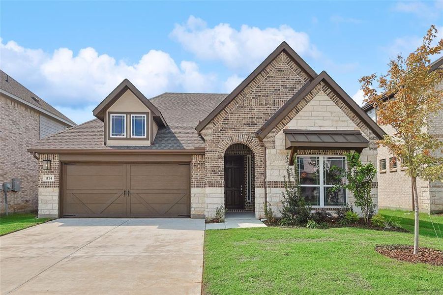 View of front of property with a garage and a front yard