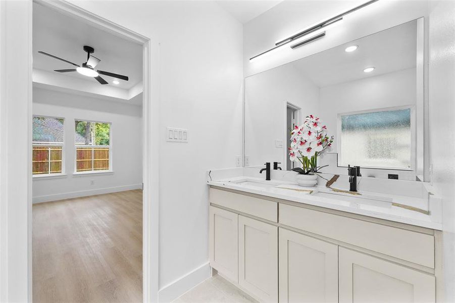 Dual vanity with integrated sinks, quartz countertop, and matte black fixtures Dual vanity with integrated sinks, quartz countertop, and matte black fixtures