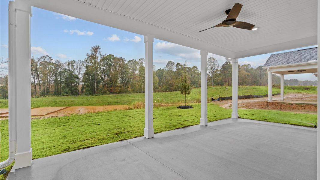 Rear covered porch creates a seamless extension of this home’s elegant design Rear covered porch creates a seamless extension of this home’s elegant design