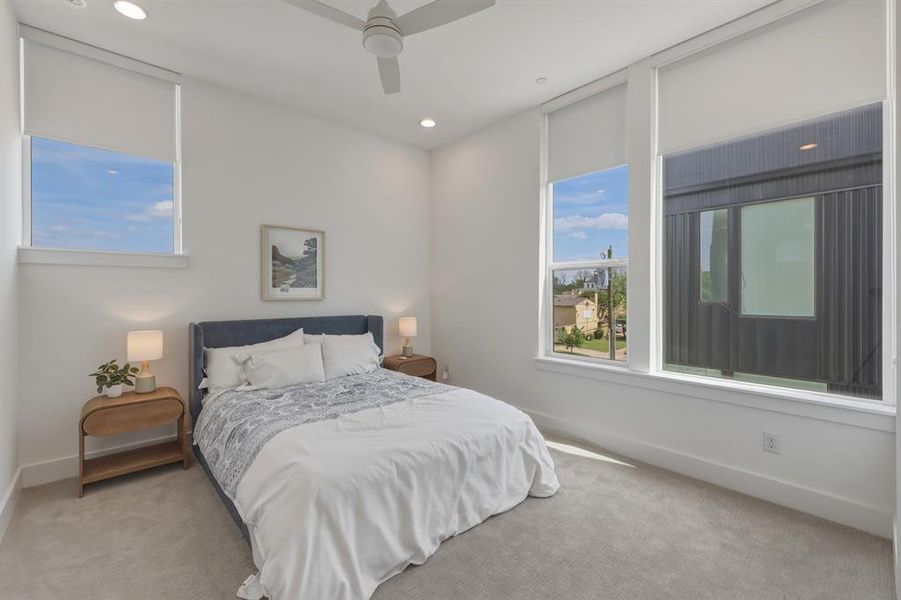 Bedroom with carpet flooring, ceiling fan, and recessed lighting