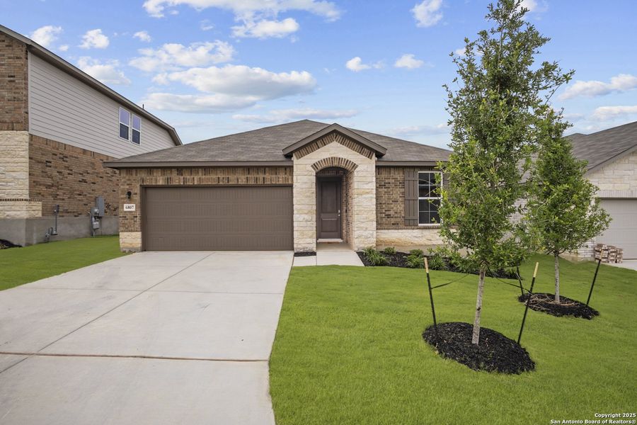 Front exterior of a new home in Comanche Ridge, San Antonio, TX, highlighting curb appeal (Image 1). Front exterior of a new home in Comanche Ridge, San Antonio, TX, highlighting curb appeal (Image 1).