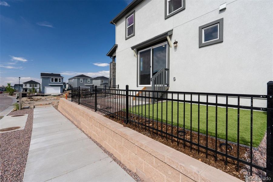 Front exterior of a new home in Revel Crossing at Wolf Ranch – The Ascent Collection, Colorado Springs, CO, highlighting curb appeal (Image 21).