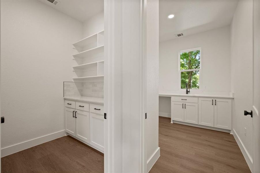 Laundry room featuring wood finished floors and recessed lighting Laundry room featuring wood finished floors and recessed lighting