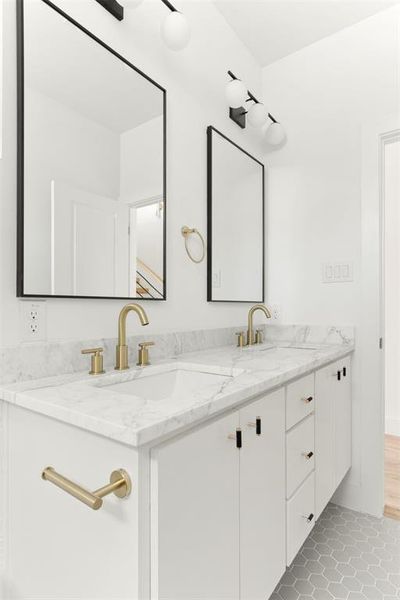 Bathroom with double vanity and tile floors