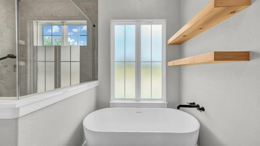Contemporary bathroom featuring a white freestanding soaking tub, dual floating wood shelves, and a large window with privacy glass