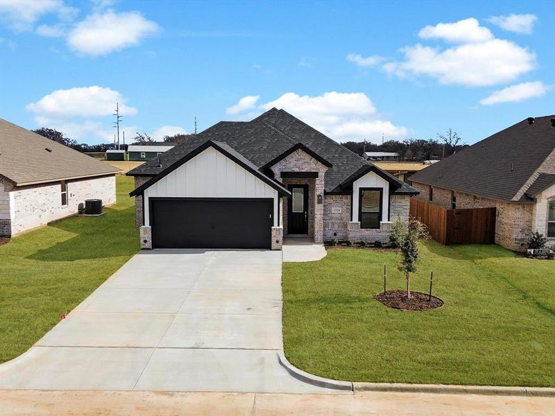 Front exterior of a new home in , Tolar, TX, highlighting curb appeal (Image 2). Front exterior of a new home in , Tolar, TX, highlighting curb appeal (Image 2).