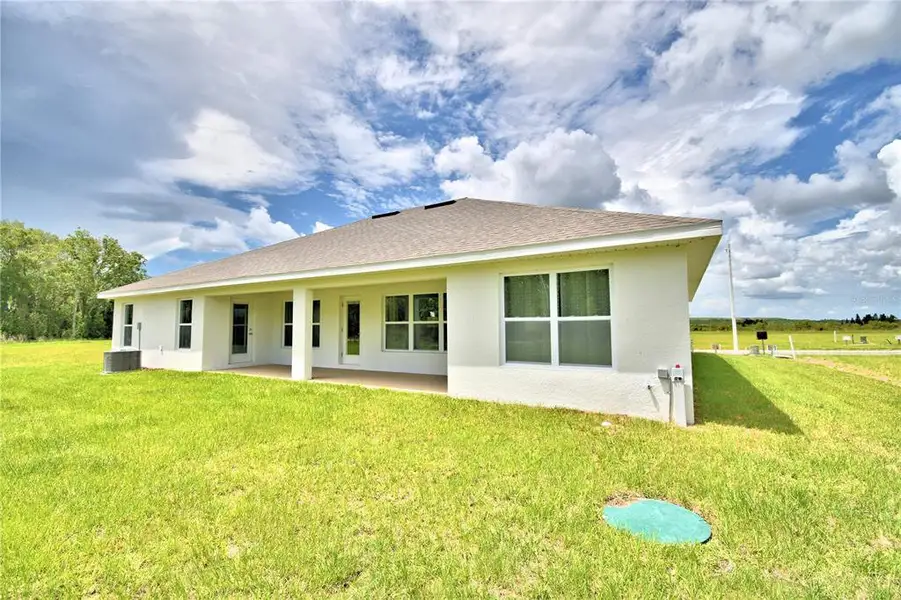Exterior details and patio area of a home in Cadence Crossing, Auburndale (Image 24).