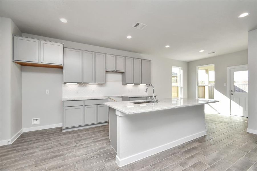 Step into a dream realized with this generously spacious kitchen! Sample photo of completed home with similar floor plan. As-built interior colors and selections may vary.