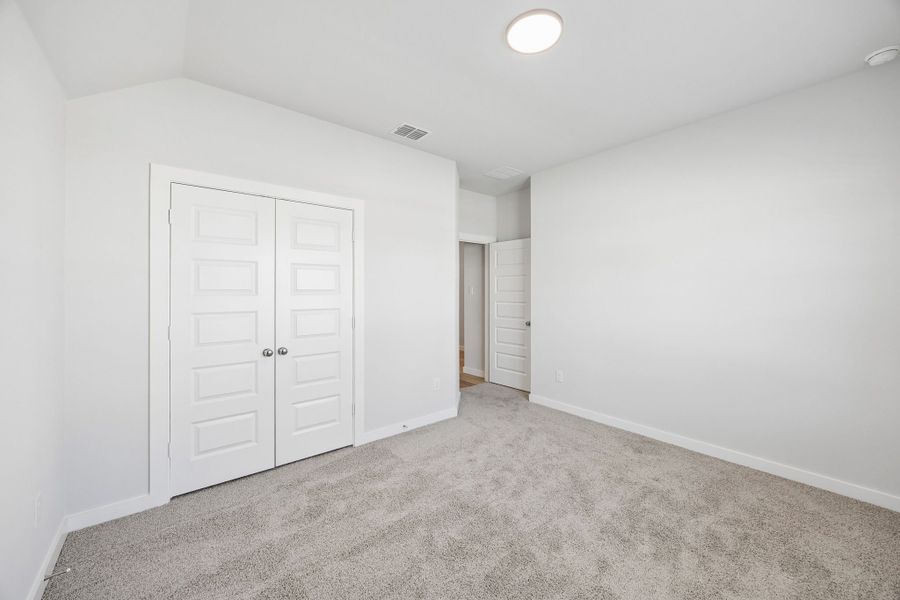 Bedroom in the Oscar home plan by Trophy Signature Homes – REPRESENTATIVE PHOTO