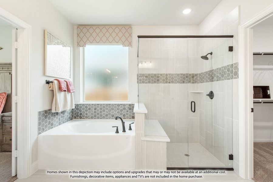 Master bathroom with soaking tub, glass-enclosed shower, hexagon tile accents, and walk-in closet entrance Master bathroom with soaking tub, glass-enclosed shower, hexagon tile accents, and walk-in closet entrance