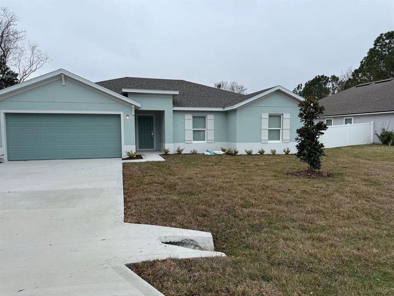 Front exterior of a new home in , Palm Coast, FL, highlighting curb appeal (Image 1). Front exterior of a new home in , Palm Coast, FL, highlighting curb appeal (Image 1).